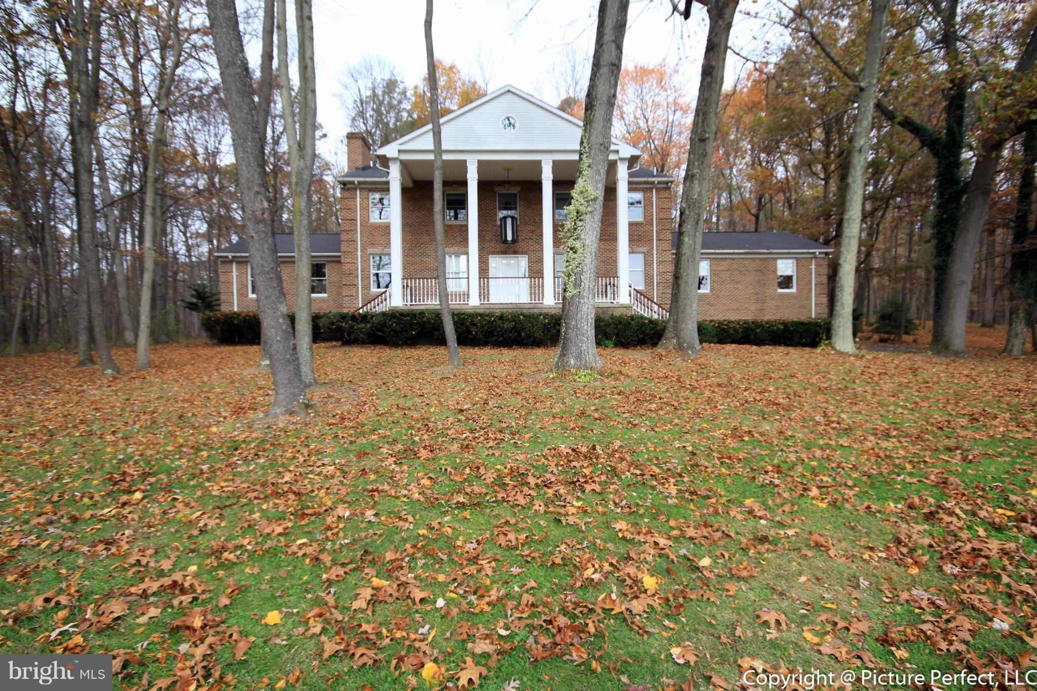 4911 Sundown Road Laytonsville, MD 20882 - Photo 2 of 21 a front view of a house with a yard