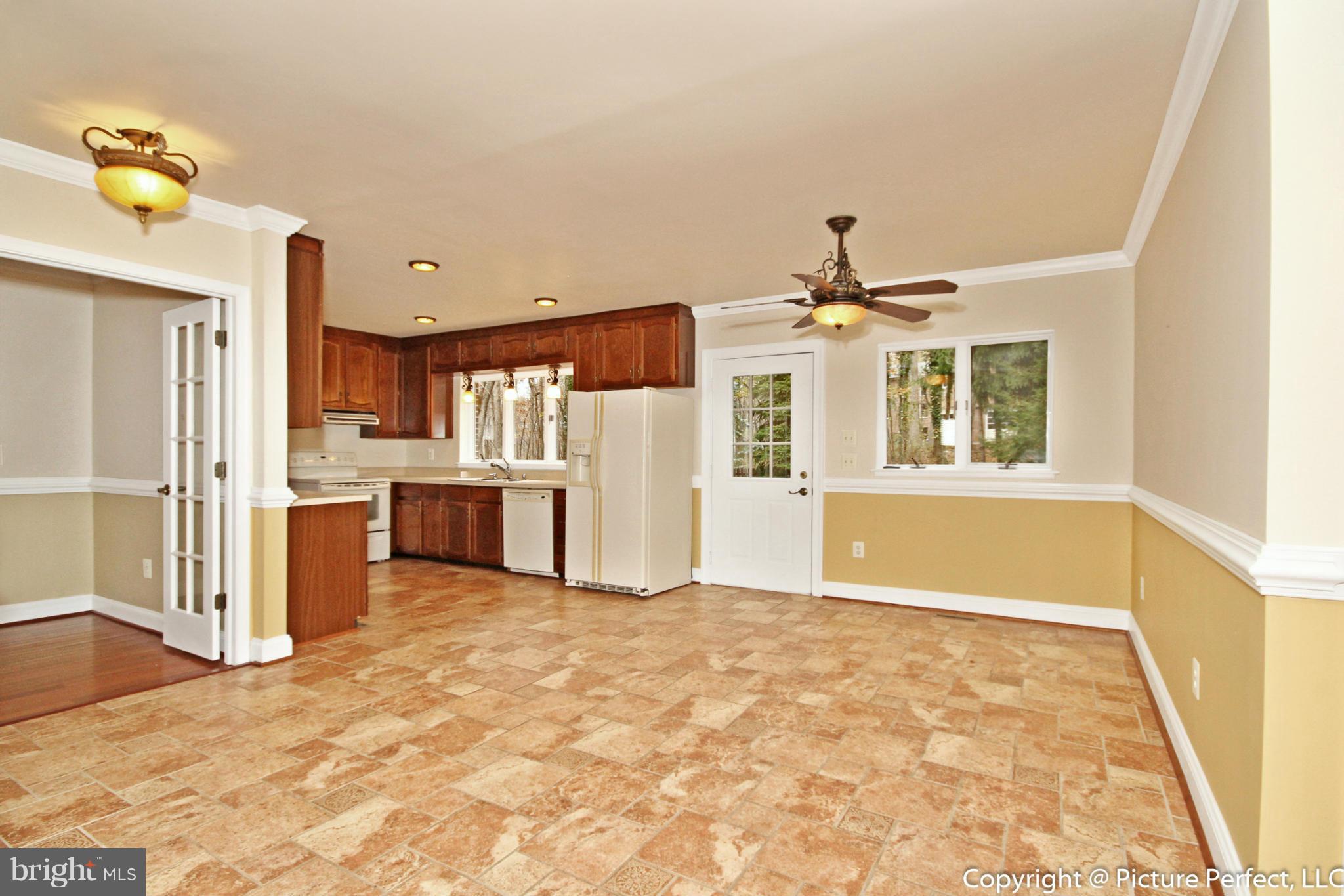 4911 Sundown Road Laytonsville, MD 20882 - Photo 11 of 21 a view of a kitchen with a sink and a refrigerator