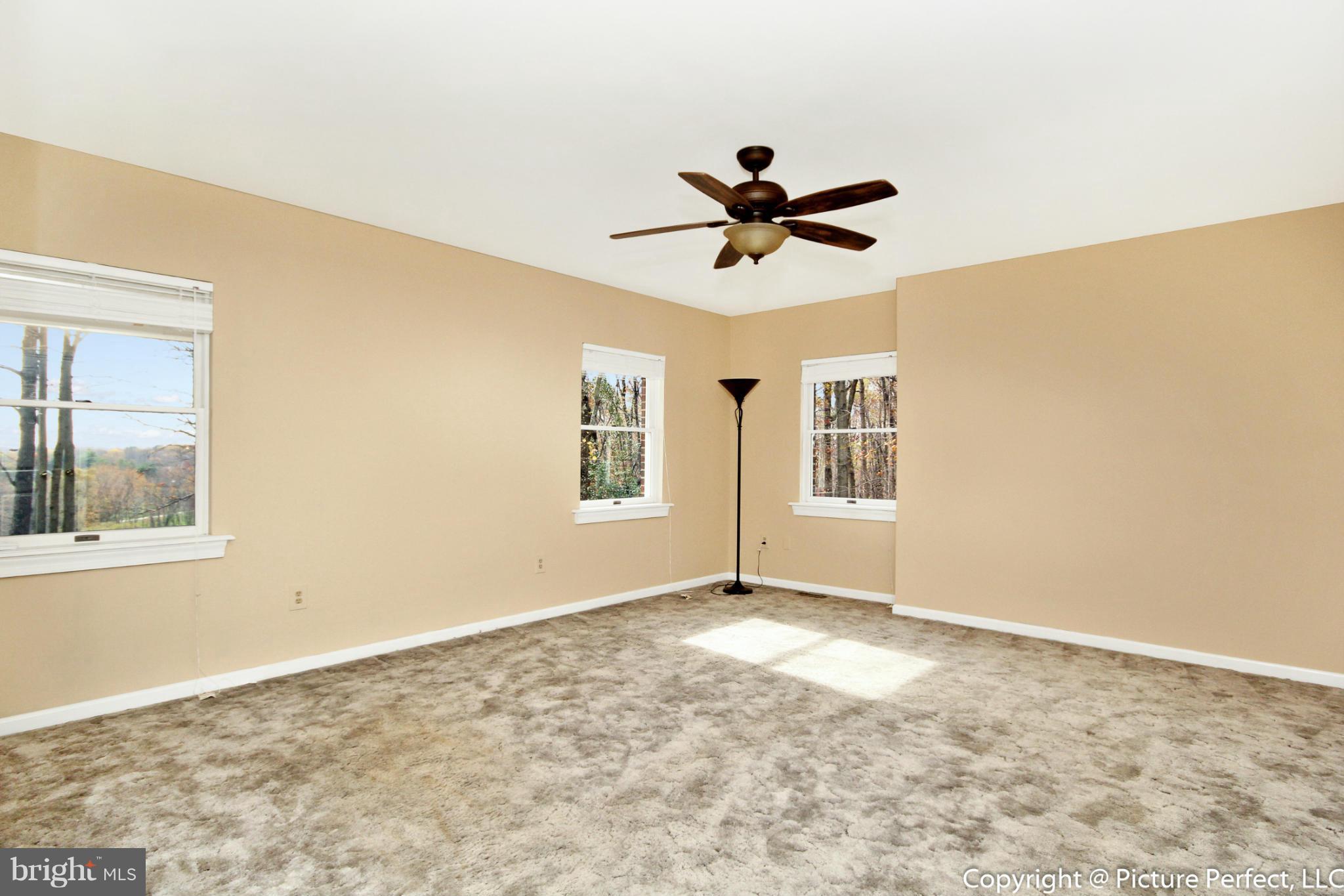 4911 Sundown Road Laytonsville, MD 20882 - Photo 17 of 21 a view of empty room with wooden floor and fan