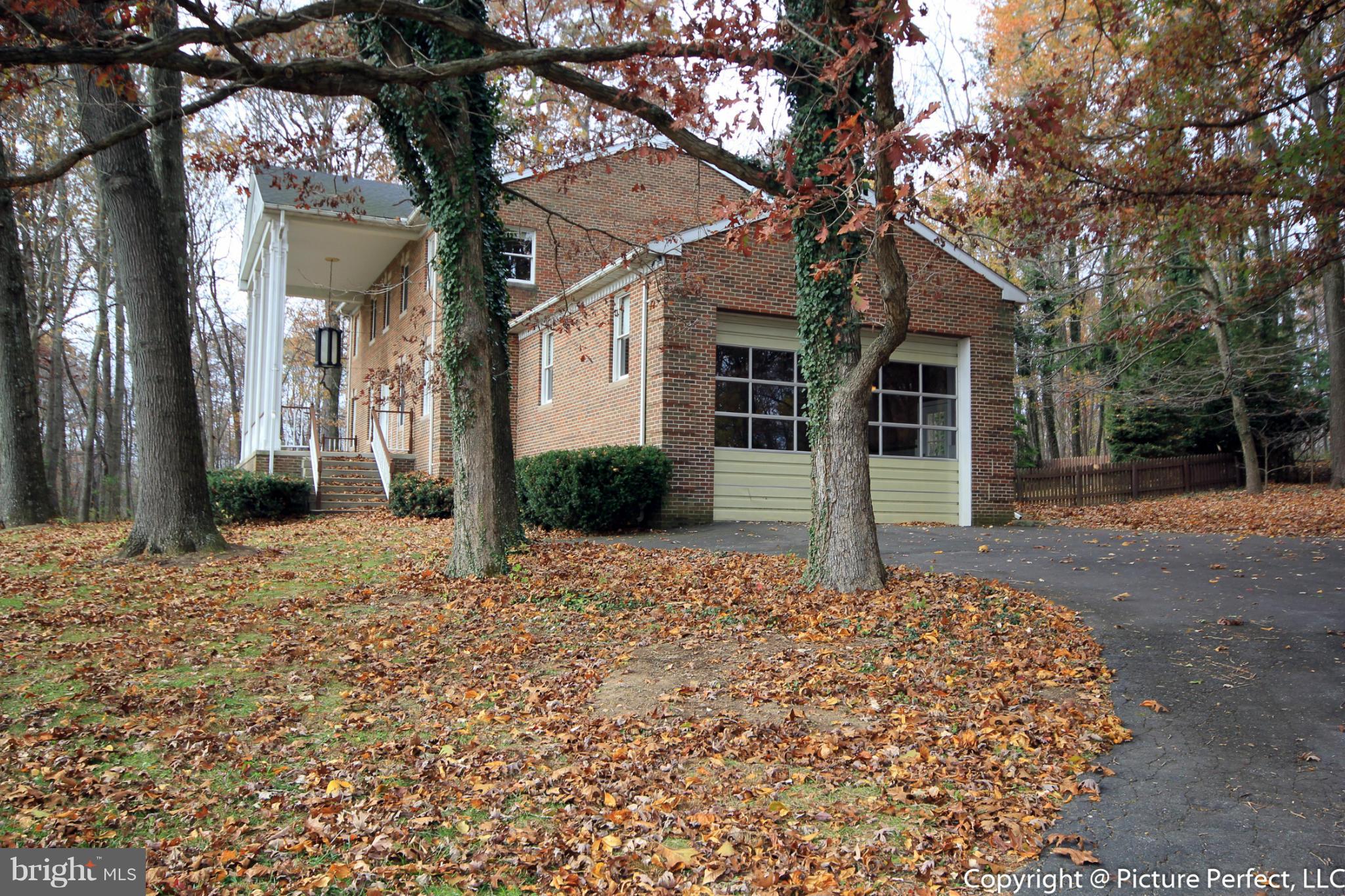 4911 Sundown Road Laytonsville, MD 20882 - Photo 20 of 21 a front view of a house with a yard and garage