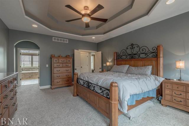 6286 Park Road Clinton, IL 61727 - Photo 11 of 45 a bedroom with a bed a chandelier and a large closet