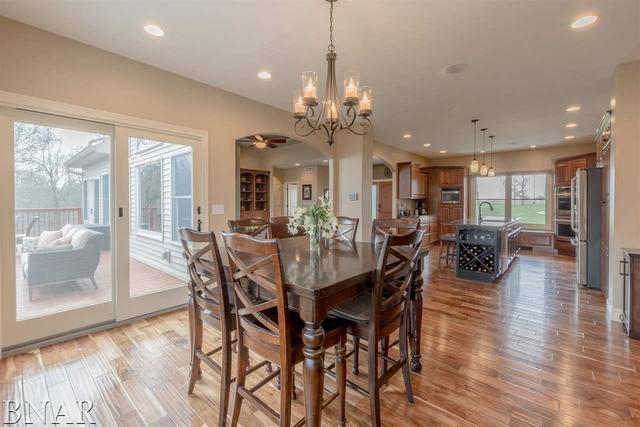 6286 Park Road Clinton, IL 61727 - Photo 15 of 45 a view of a dining room and livingroom with furniture wooden floor a chandelier