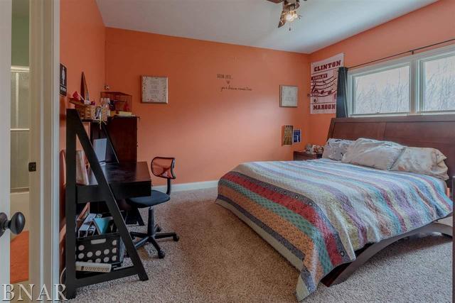 6286 Park Road Clinton, IL 61727 - Photo 18 of 45 a bedroom with a bed a desk and chair with the wooden floor