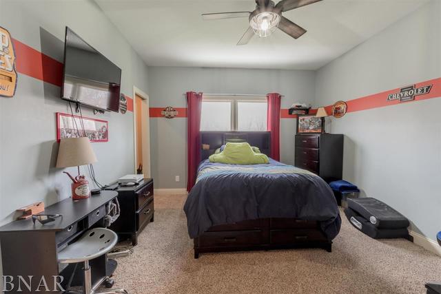 6286 Park Road Clinton, IL 61727 - Photo 20 of 45 a bedroom with a bed and a ceiling fan