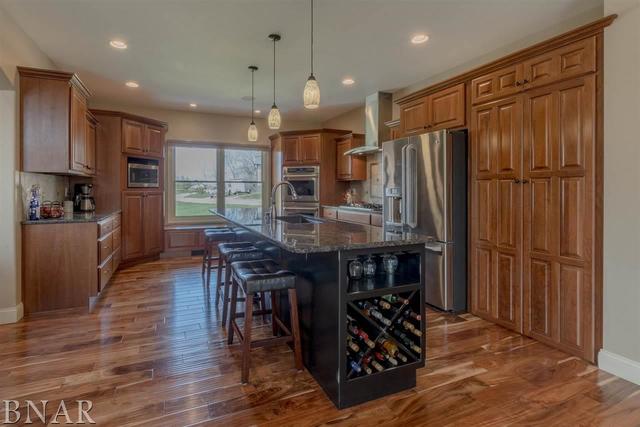 6286 Park Road Clinton, IL 61727 - Photo 4 of 45 a kitchen with stainless steel appliances granite countertop a stove refrigerator and wooden floor