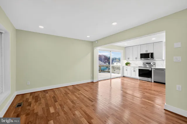 a view of kitchen with stainless steel appliances a refrigerator and a stove top oven