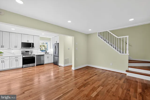 a view of kitchen with sink and wooden floor
