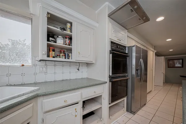 a kitchen with a sink stainless steel appliances and cabinets
