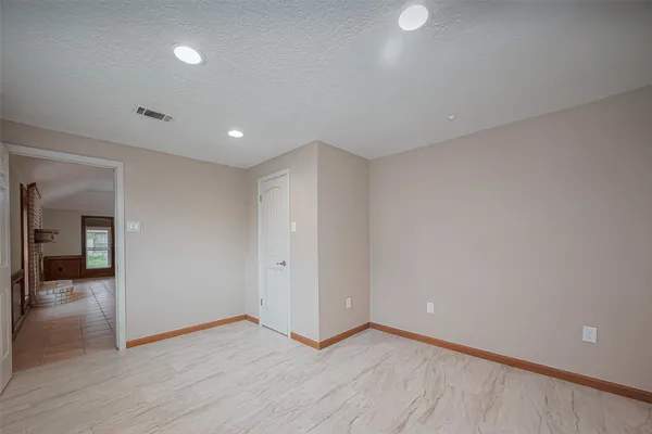 a view of an empty room and wooden floor