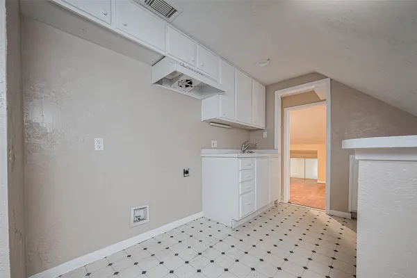 a room with a walk in closet and wooden floor