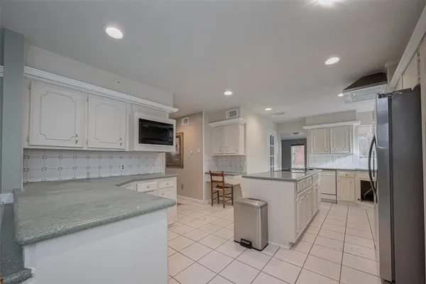 a kitchen with a sink appliances and cabinets
