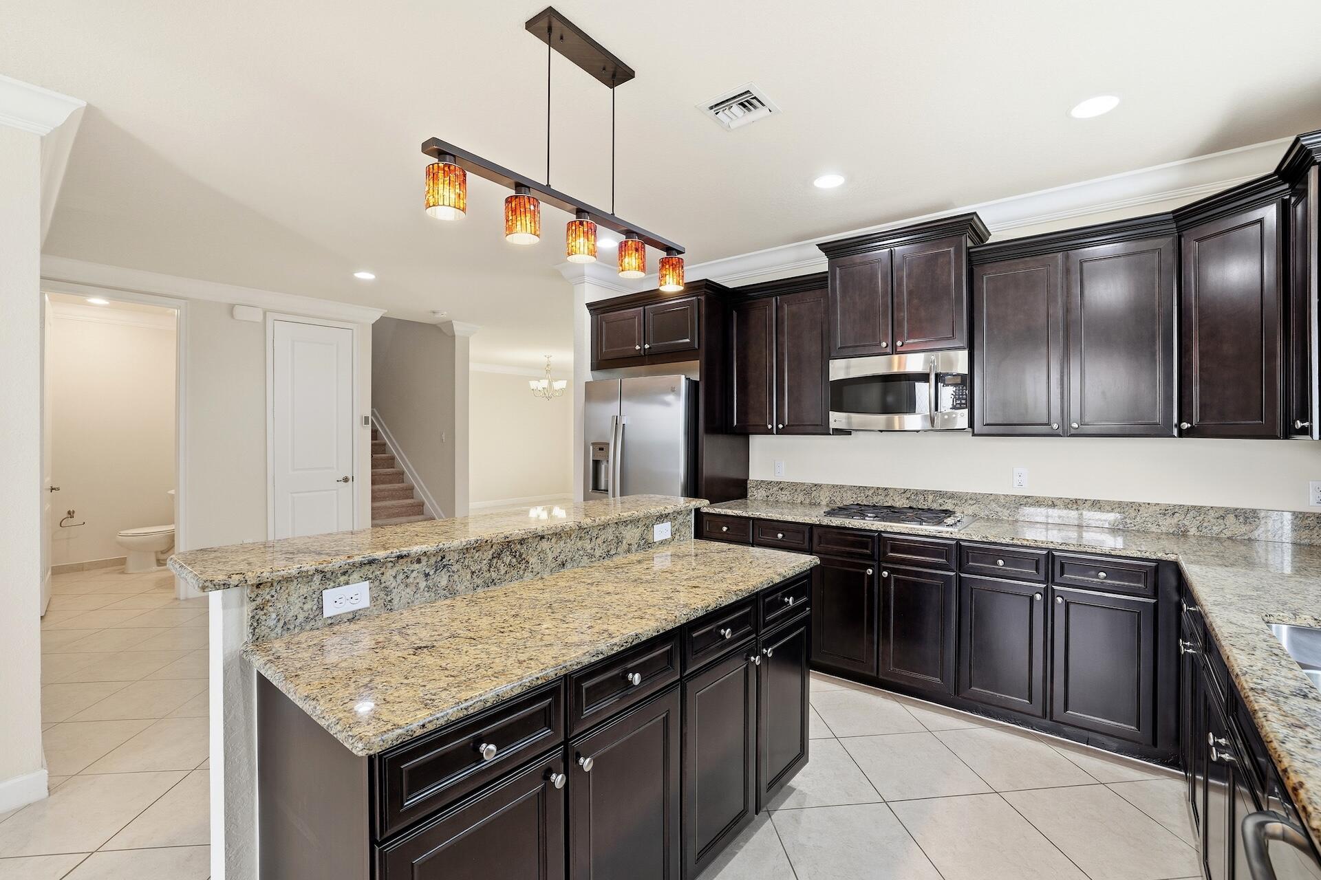 148 Northwest Emerson Place Boca Raton, FL 33432 - Photo 11 of 44 Kitchen & Half Bath