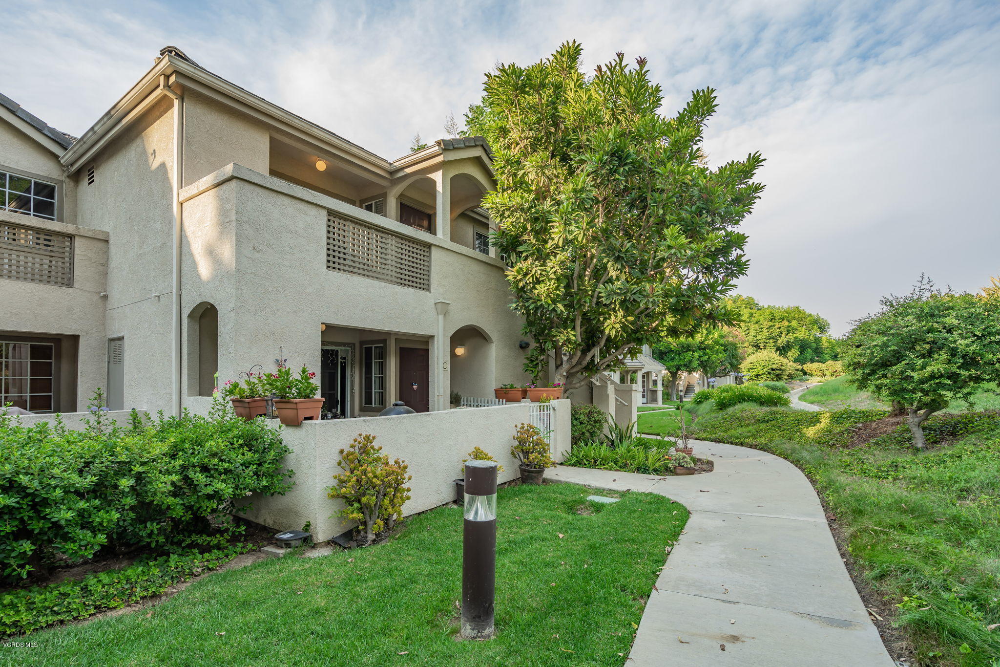 1067 Waltham Road, Unit D Simi Valley, CA 93065 - Photo 1 of 31 a front view of a house with a garden