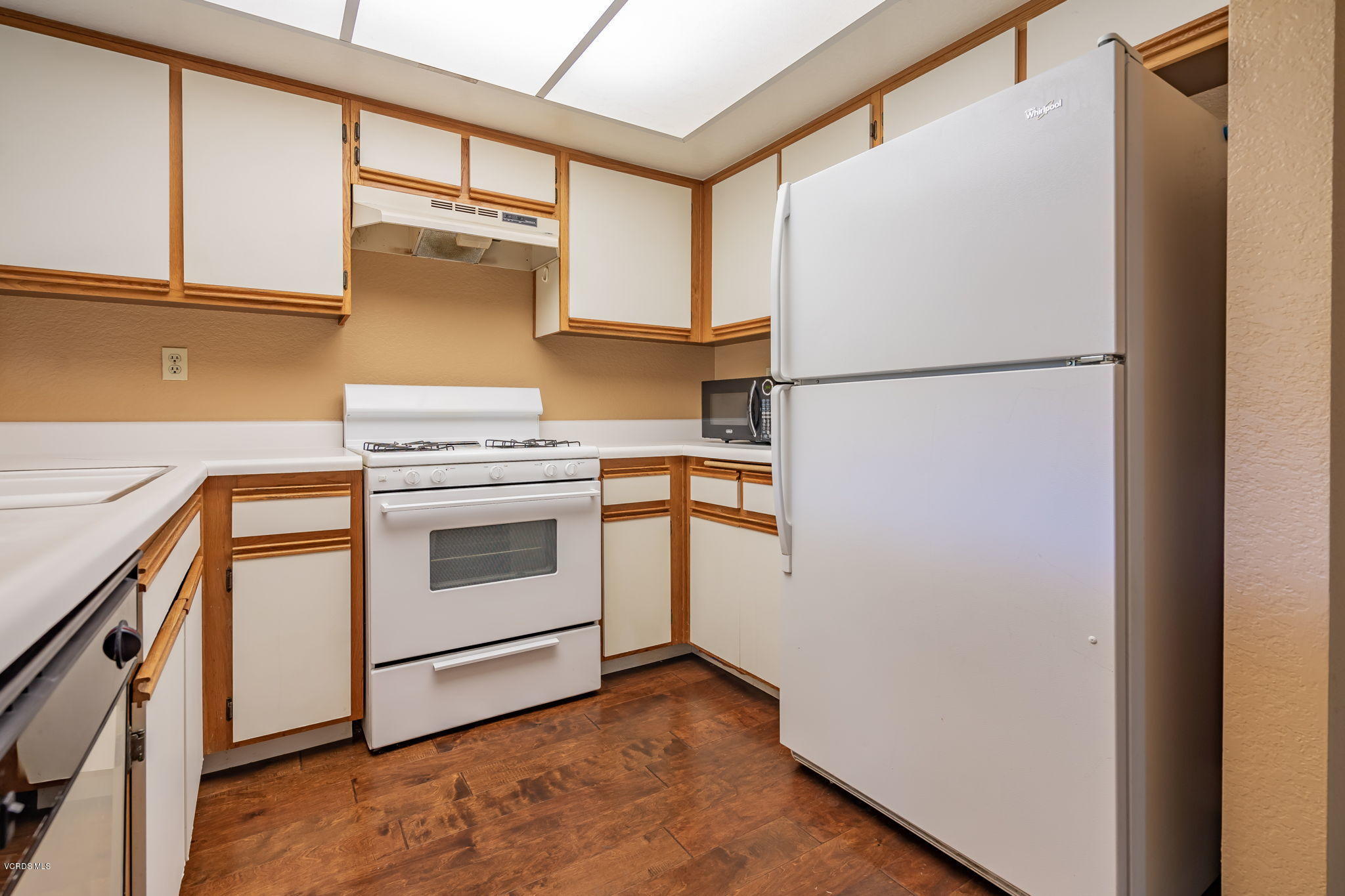 1067 Waltham Road, Unit D Simi Valley, CA 93065 - Photo 13 of 31 a kitchen with a refrigerator sink stove and cabinets