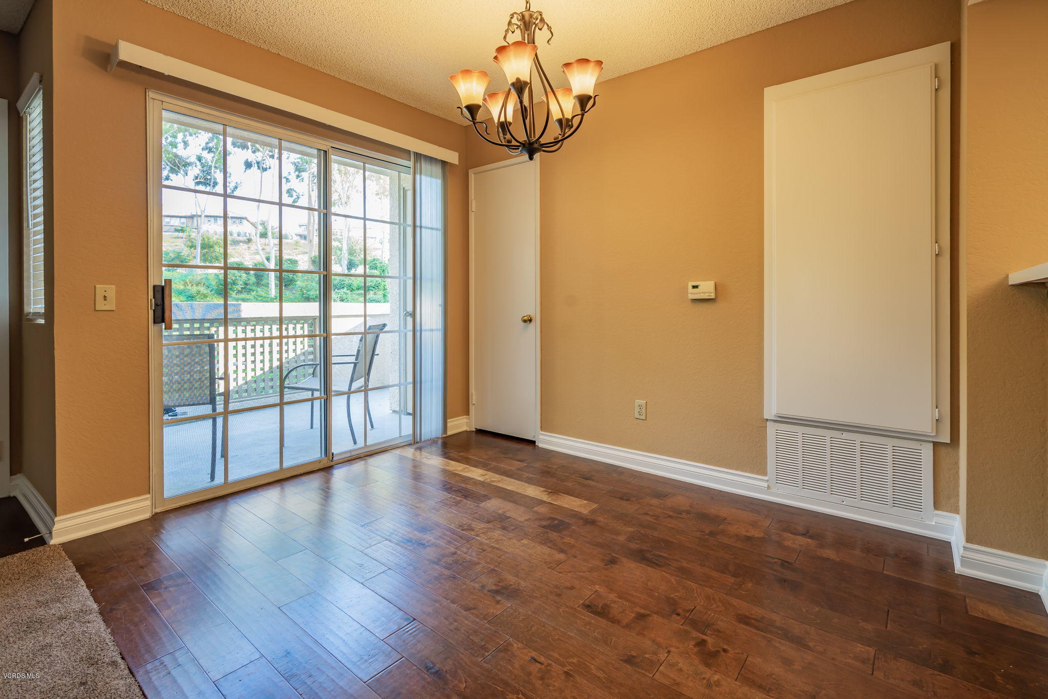 1067 Waltham Road, Unit D Simi Valley, CA 93065 - Photo 10 of 31 a view of an empty room with wooden floor and a window