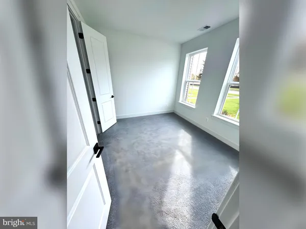 a bathroom with a granite countertop sink toilet and mirror
