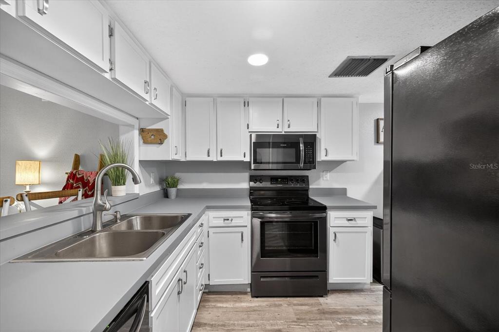 3230 Teeside Drive New Port Richey, FL 34655 - Photo 8 of 32 a kitchen with a sink stove and refrigerator