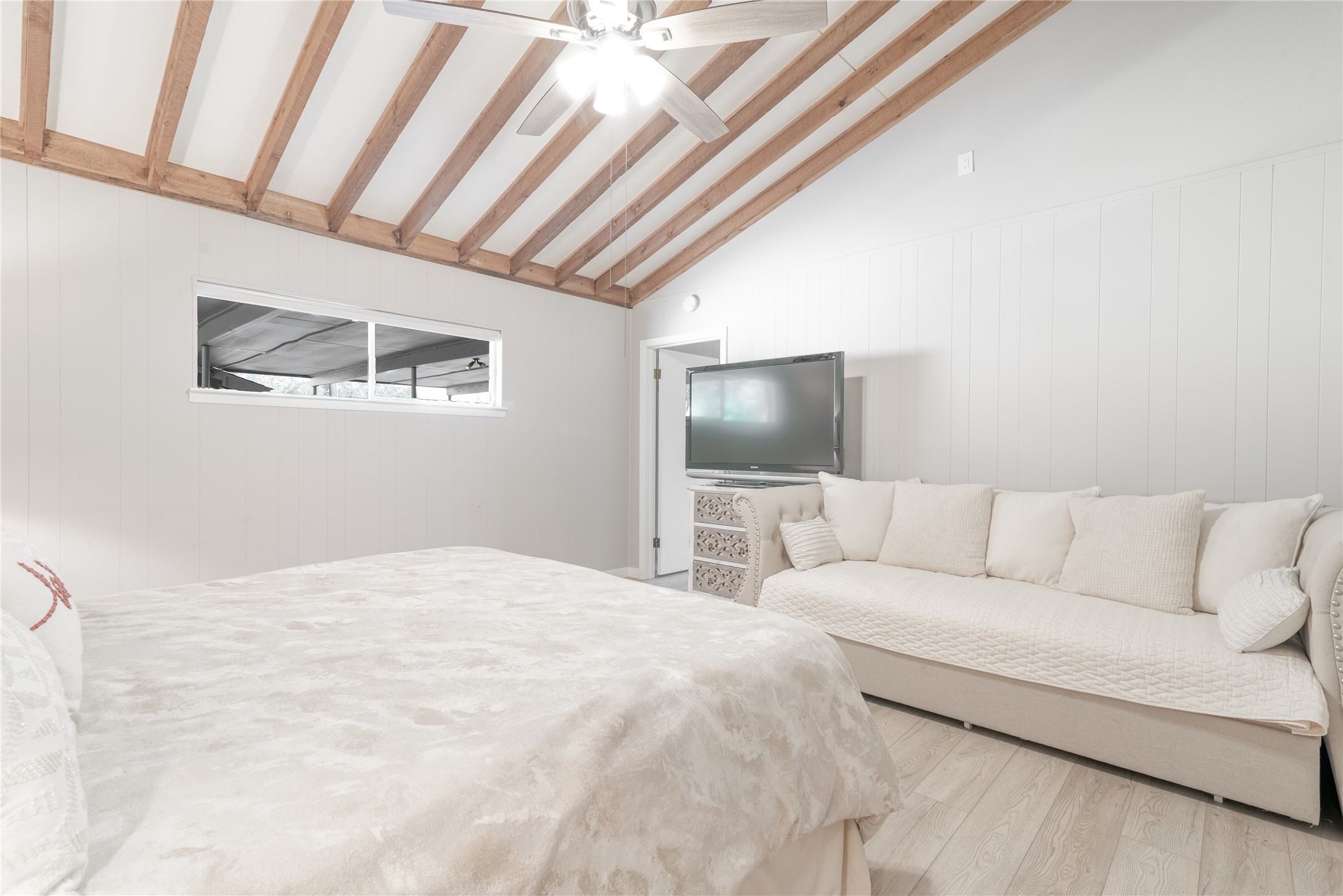 3807 Boat Dock Road Lago Vista, TX 78645 - Photo 12 of 37 Exposed wood beams create architectural interest in this bright, inviting sleeping space.