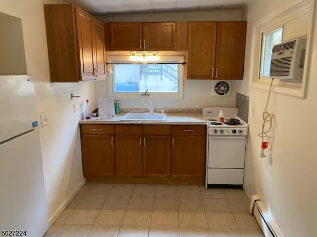 a kitchen with a stove sink and cabinets