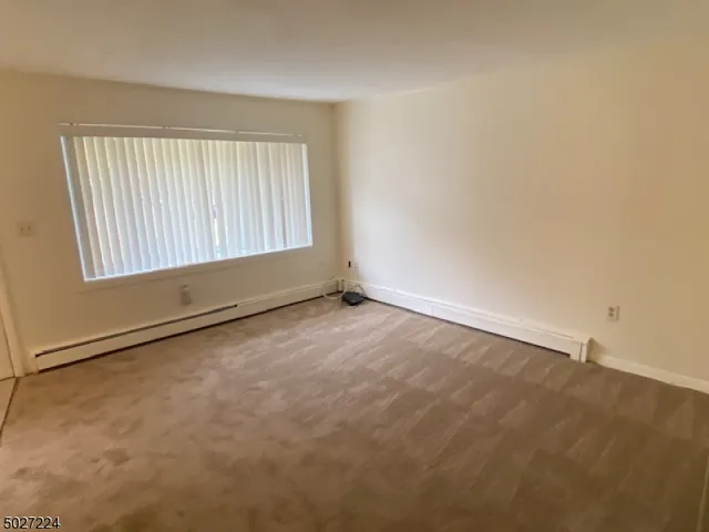 an empty room with a empty space and windows