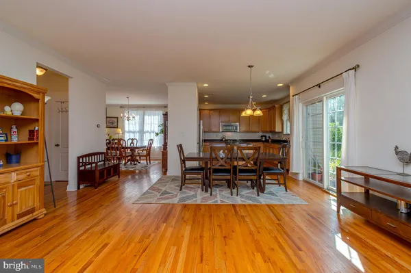 a dining room with furniture and wooden floor