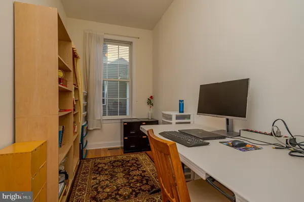 a kitchen with a sink stove and wooden floor