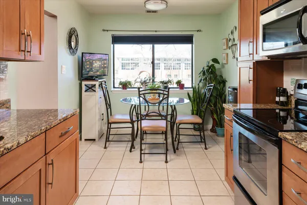 a kitchen with granite countertop a sink and a stove top oven