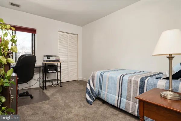 a bedroom with a bed and a chair