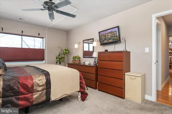 a bedroom with a bed and a dresser