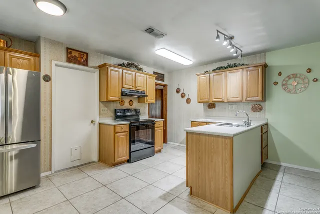a kitchen with a refrigerator sink and stove