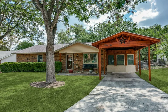 a front view of a house with yard and porch