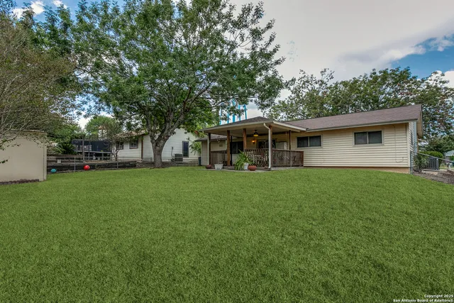 a view of house with backyard