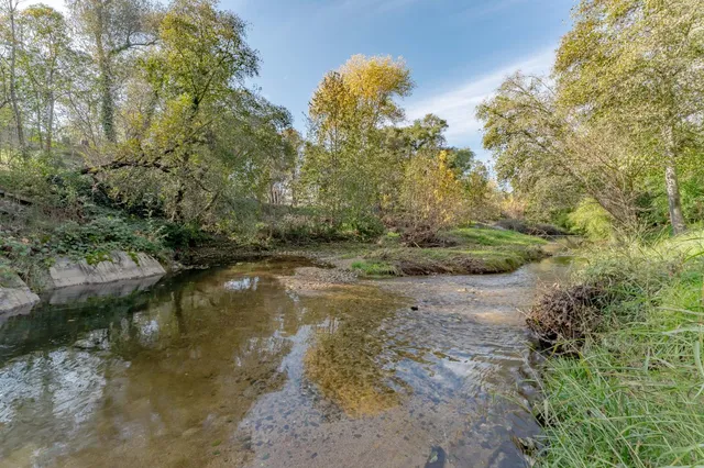 a view of a house with a yard and sitting area