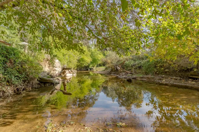 a living room with furniture a flat screen tv and a window