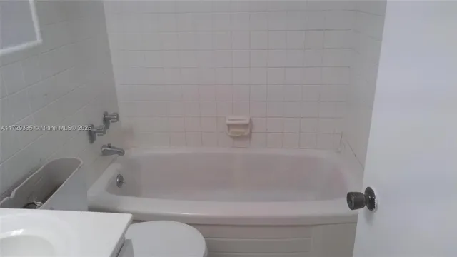 a view of an empty room with a kitchen