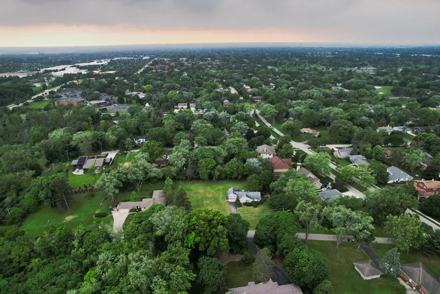 an aerial view of residential houses with city and lake view