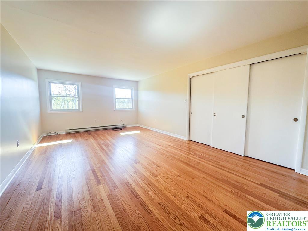1350 Kunkletown Road, Unit 201 Saylorsburg, PA 18353 - Photo 12 of 15 an empty room with wooden floor and windows