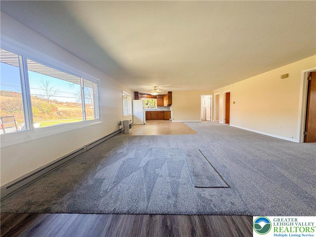 1350 Kunkletown Road, Unit 201 Saylorsburg, PA 18353 - Photo 4 of 15 a view of empty room with wooden floor and fan