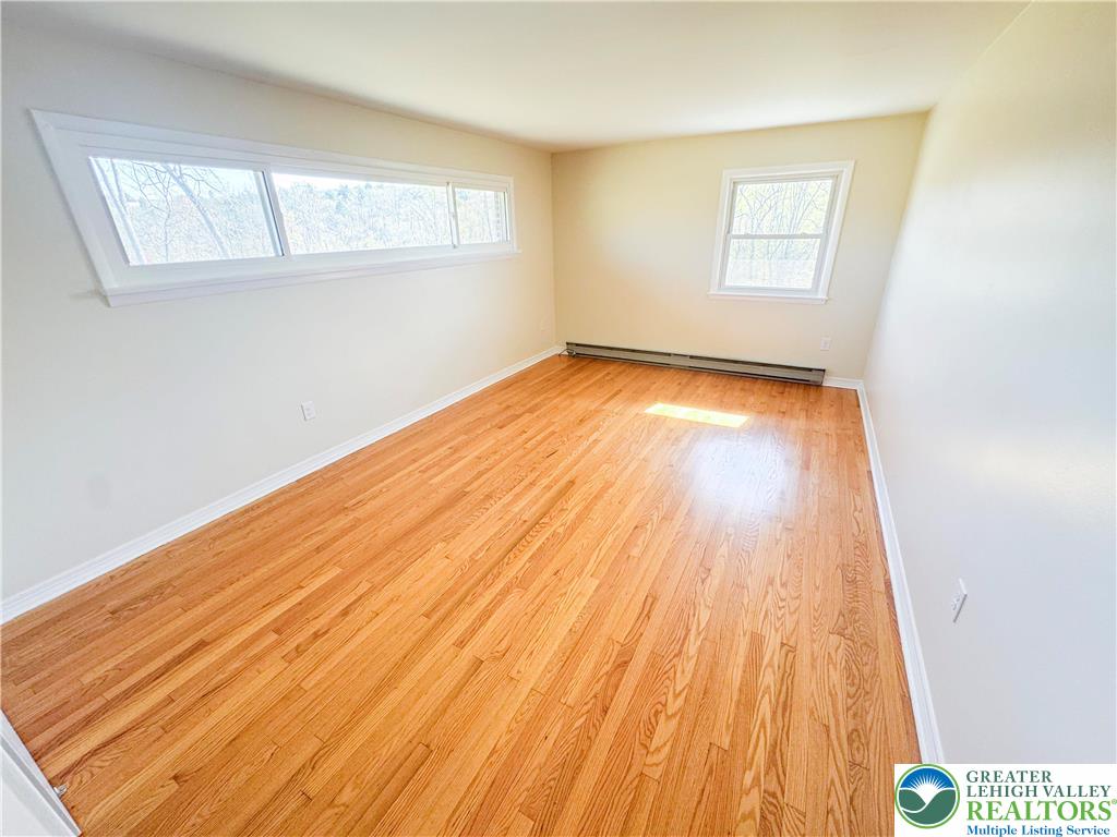 1350 Kunkletown Road, Unit 201 Saylorsburg, PA 18353 - Photo 9 of 15 an empty room with wooden floor and windows