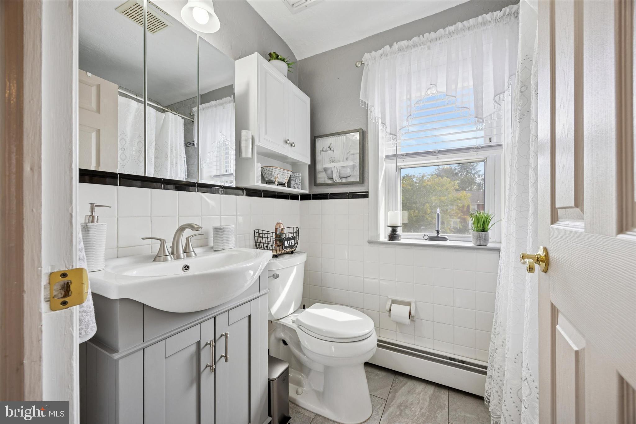 730 Dutton Circle Springfield, PA 19064 - Photo 21 of 38 a bathroom with a sink a toilet and a mirror