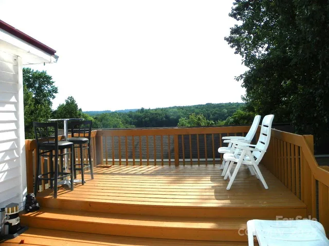 a view of two chairs and table in the patio