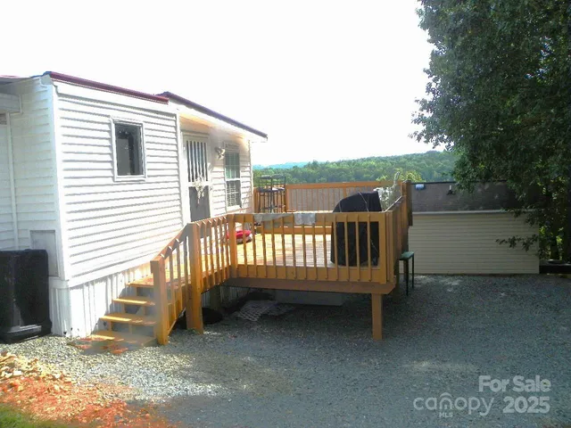 a view of a deck with a bench and wooden floor