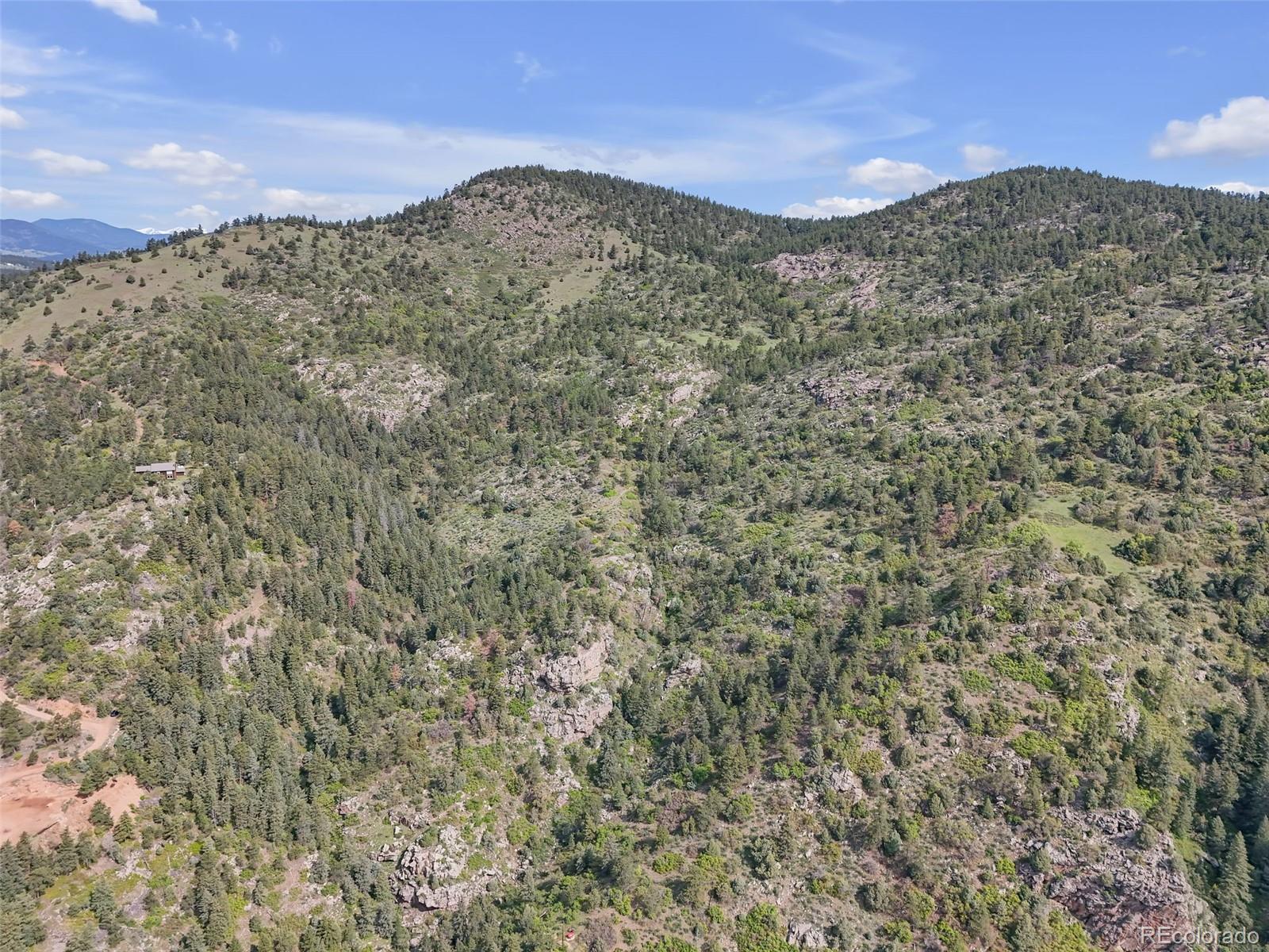 0 Raven Gulch Road Indian Hills, CO 80454 - Photo 20 of 21 a view of a large mountain with mountains in the background