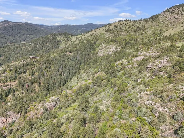 a view of a large building with mountains in the background