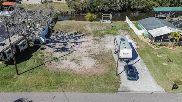 an aerial view of a house with a yard