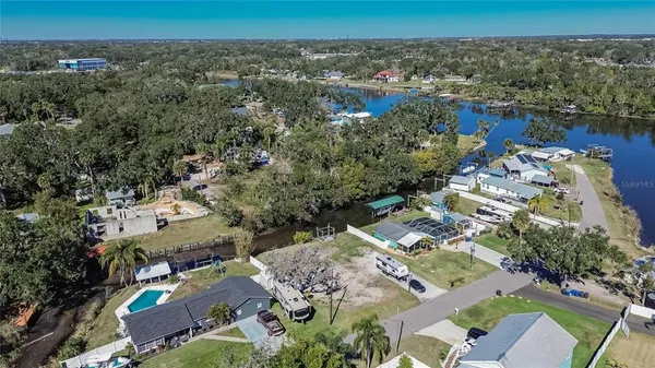 an aerial view of a house with a yard and lake view