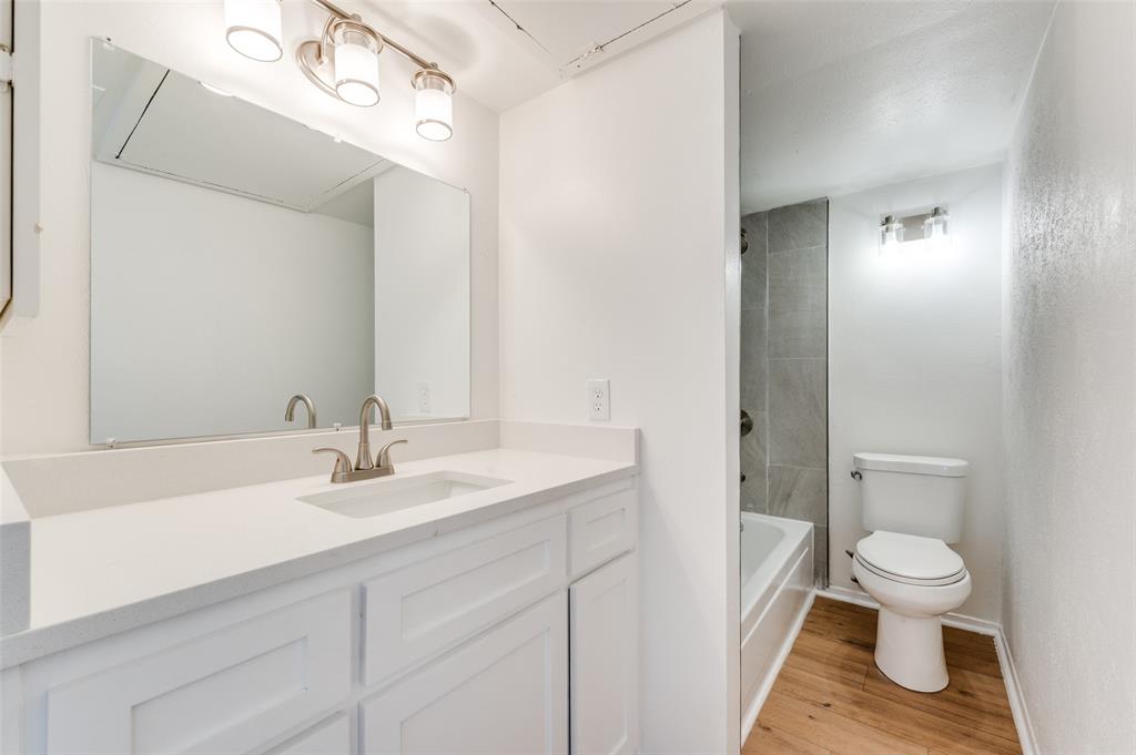 4859 Cedar Springs Road, Unit 337 Dallas, TX 75219 - Photo 2 of 20 a bathroom with a sink vanity granite and toilet