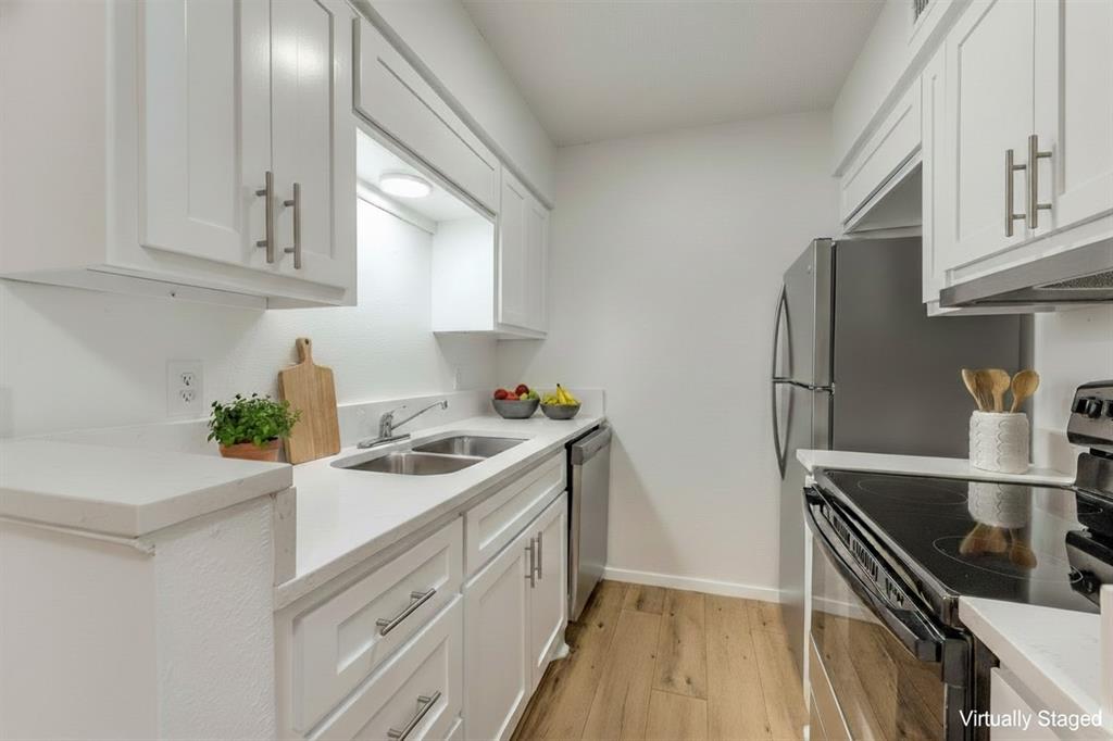 4859 Cedar Springs Road, Unit 337 Dallas, TX 75219 - Photo 3 of 27 a kitchen with stainless steel appliances granite countertop a sink stove and refrigerator