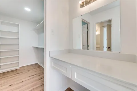 a view of kitchen cabinets and wooden floor