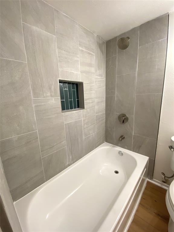 4859 Cedar Springs Road, Unit 337 Dallas, TX 75219 - Photo 6 of 20 a bathroom with a white tub